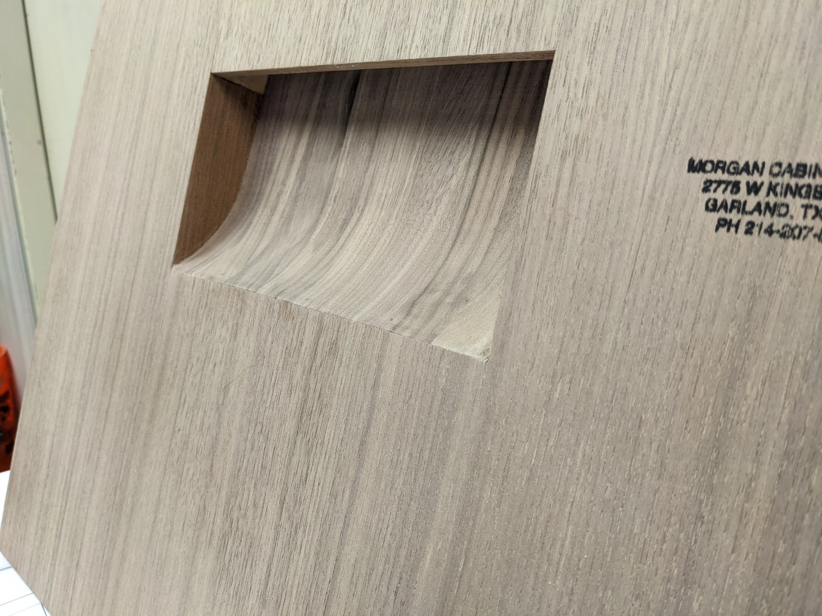 Unfinished walnut fabrication sample showing the integrated curved recess